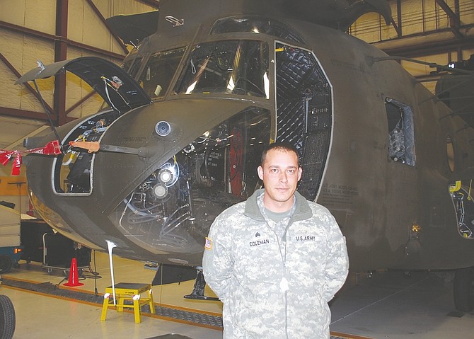 Steve Ranson / Lahontan Valley NewsSgt. Jason Coleman of Carson stands next to a Nevada Army National Guard CH-47 helicopter on Friday. Bravo Company, 1-189th General Support Aviation Battalion, will deploy to Afghanistan later this month.