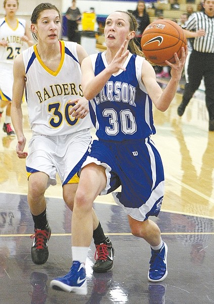 Shannon Litz / Nevada Appeal Kaitlyn Holmes of Carson drives in the paint against Reed&#039;s Sierra Hooft during the Senators&#039; 67-35 loss Thursday night in Sparks.