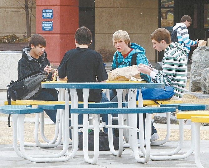 Jim Grant / Nevada AppealCarson High School freshmen, from left, Aaron Woodbury, Joey Cusumano, Corey Reid and Jimmy Redlark eat lunch outside on a chilly afternoon on Monday.