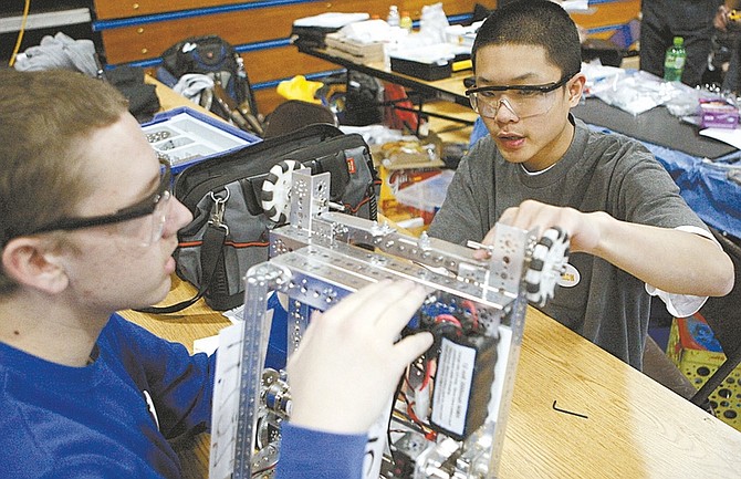 Shannon Litz/Nevada AppealFifteen-year-olds Tyler Wittich and Toan Chung of the Railroaders team from Sparks prepare their robot on Saturday at Carson High School.