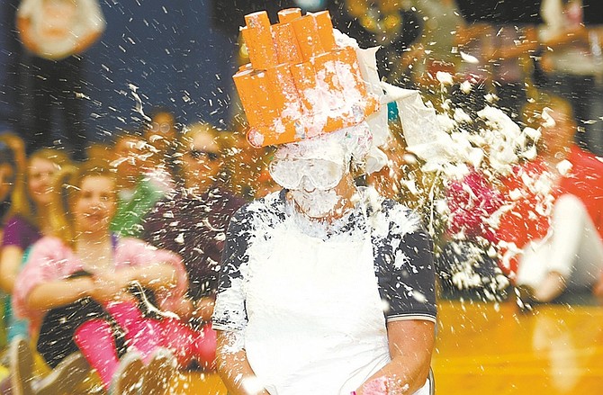 Shannon Litz / Nevada AppealMaria Sauter takes a pie in the face while wearing a homemade crown at the Dayton Intermediate School assembly on Wednesday.