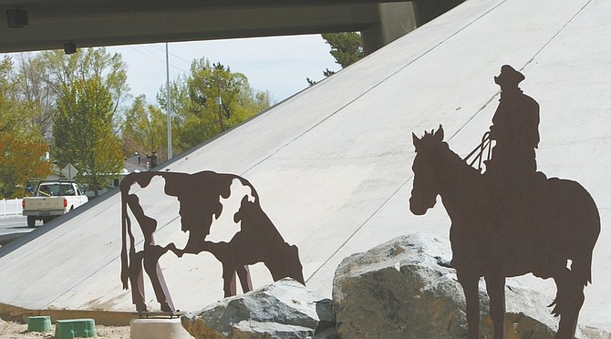 photos by Jim Grant/Nevada Appeal A cowboy tends to cattle at the freeway overpass on Northgate Lane. The Northgate Lane and Emerson Drive grade separation shares a dual theme, with cattle images portraying the Sam Davis Ranch theme on the north side. Murals depicting Pony Express riders are depicted on the other side