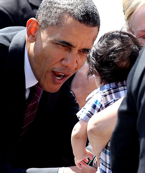 President Barack Obama greets a baby in the crowd at the Reno-Tahoe International Airport in Reno, Nev., Friday, May 11, 2012. (AP Photo/Cathleen Allison)