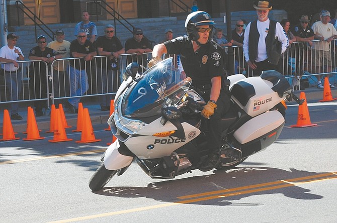 Geoff Dornan / Nevada AppealOfficer Quinn Redeker of the Ventura Police Department leans his BMW motorcycle through the obstacle course on Carson Street Saturday on his way to winning this year&#039;s Extreme Motor Officer Challenge.