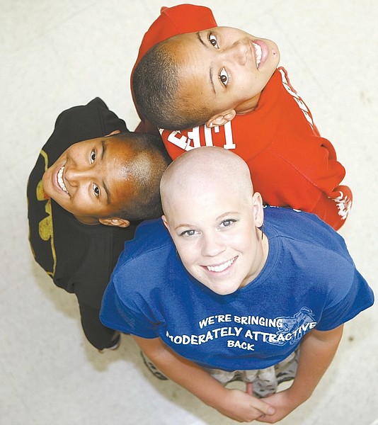 Shannon Litz /Nevada AppealCarson High School sophomore Jermijah Thompson, top, senior Hannah Novak, right, and junior Lydia Lopez shaved their heads as part of a fundraiser for Northern Nevada Children&#039;s Cancer Foundation.