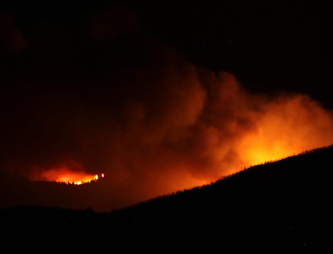 Nancy Vary Hulsey/Special to The R-CFlames from the Carter Springs fire illuminate the night sky.