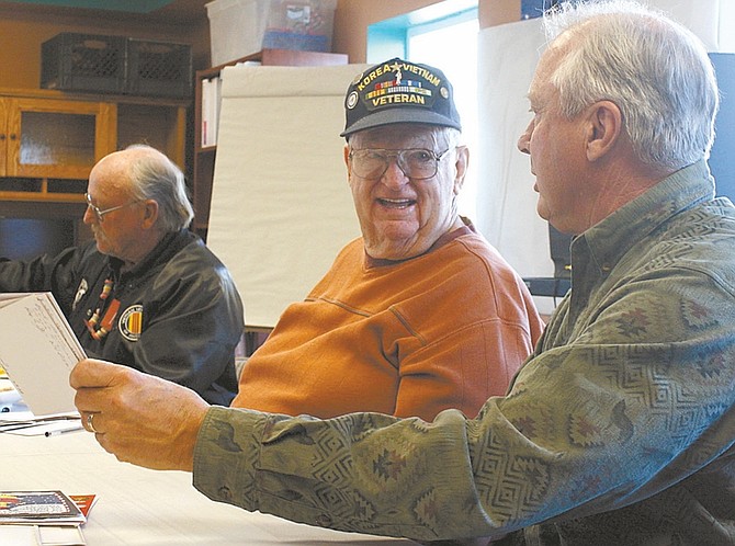 Photos by Wheeler Cowperthwaite / Nevada AppealRight: Rex Jennings, right, talks to Bud Harris, with Christmas cards to be sent to troops overseas.
