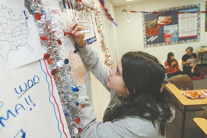 Jim Grant / Nevada AppealCarson High School senior Angela Martin colors in an electoral college map at an election watch party at the high school on Tuesday night.