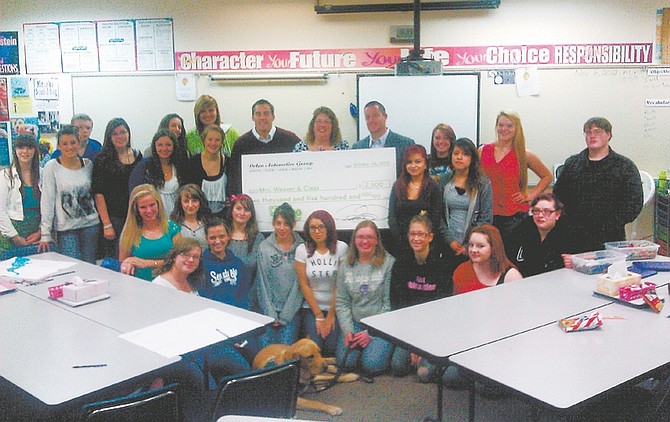 CourtesyMrs. Weaver&#038;#8217;s class receives a $2,500 check from Dolan Automotive.