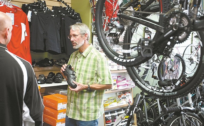 Shannon Litz / Nevada Appeal Denis Coyne of the Bike Habitat talks to a customer about cycling shoes on Friday morning.