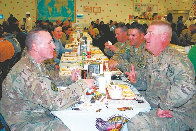 Steve Ranson / Lahontan Valley News Nevada Army National Guardsmen, who are assigned to the 593rd Transportation Company, celebrate Thanksgiving at Camp Phoenix, Afghanistan. Sgt. First Class John Dube of Minden, right, and 1st Sgt. Harry Schroeder of Reno enjoy in some conversation during dinner. Sitting next to Dube, who works full-time for the Guard in Carson City, are company commander Capt. Curt Kolvet of Reno and 1st Lt. Christopher Yell of Elko. Behind Schroeder are lieutenants Chris Jones of Reno and Yelena Yatskikh of Las Vegas.