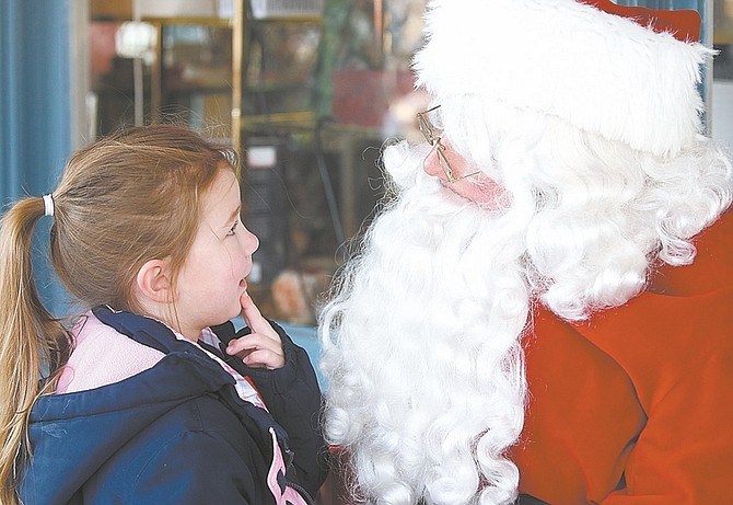 Shannon Litz / Nevada AppealFive-year-old Mikayla Gould tells Santa what she would like for Christmas on Saturday at Telegraph Square.