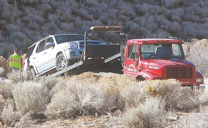 Shannon Litz / Nevada AppealA tow truck removes a vehicle in Voltaire Canyon on Thursday.