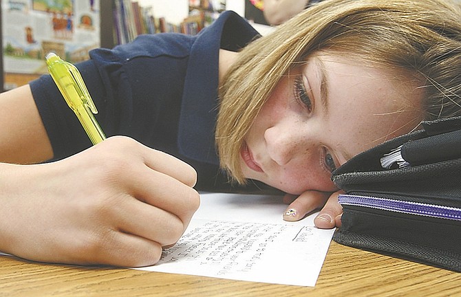 Jim Grant / Nevada AppealCarson Middle School student Kimberlinn Tarantino writes a letter during social studies class to the survivors of the deadly school shooting in Newton, Conn. on Friday.