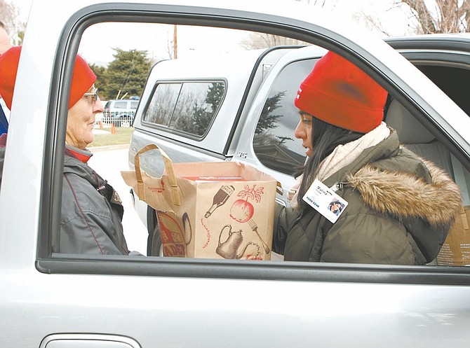 Shannon LitzVolunteer Jackie Stroud and Marina Hawk of the Food Bank of Northern Nevada unload donations from a car at the Governor&#038;#8217;s Mansion on Friday.