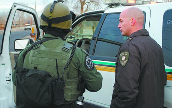Steve RansonChurchill County Sheriff Ben Trotter, right, confirms with a SWAT officer from the Lyon County Sheriff&#039;s Officer before the team entered  residence looking for a man who had allegedly shot his former girlfriend.