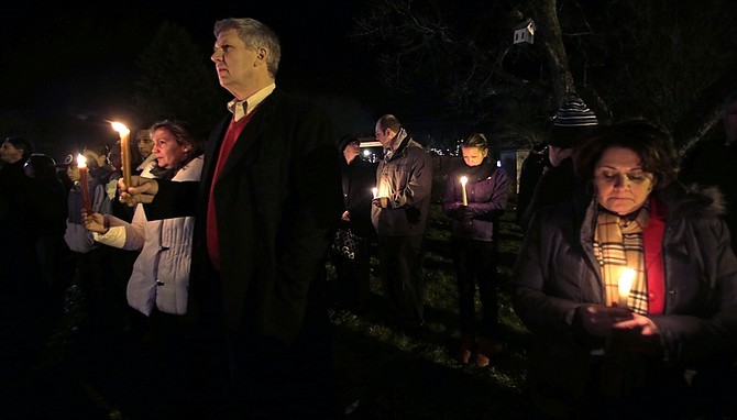 Men and women hold candles in vigil outside St. Rose of Lima Roman Catholic Church during a healing service held in for victims of an elementary school shooting in Newtown, Conn., Friday, Dec. 14, 2012.  A gunman opened fire at Sandy Hook Elementary School in the town, killing 26 people, including 20 children. (AP Photo/Charles Krupa)