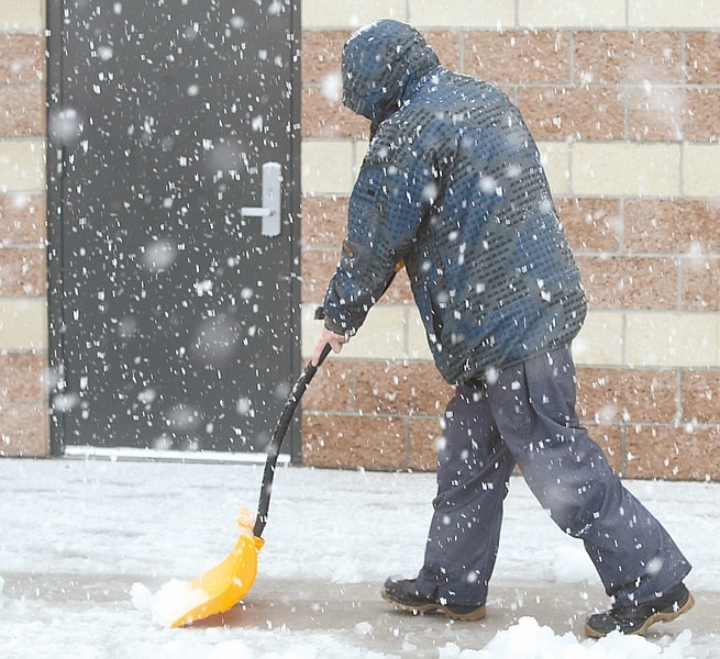 Shannon Litz / Nevada AppealA man shovels snow on Saturday afternoon in Carson City.