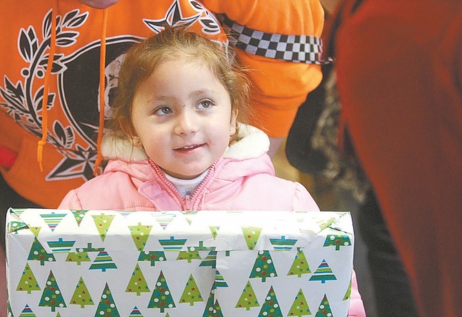 Photos by Shannon Litz / Nevada AppealThree-year-old Alicia Galvan says thank you for her gift on Saturday during Increasing the Joy, organized by Capital Christian Center.