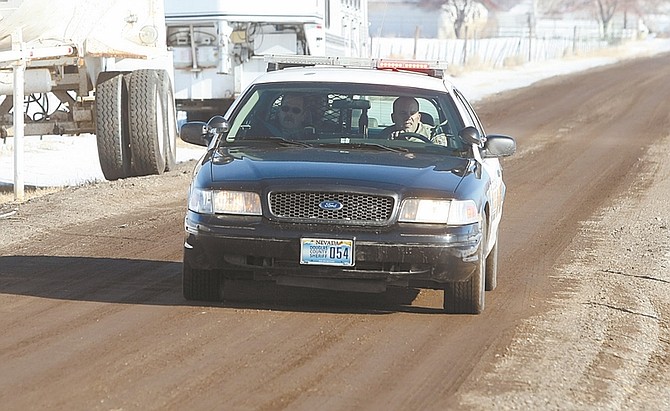 Shannon LitzDouglas County deputies, with a suspect in custody, leave the scene on Friday afternoon.