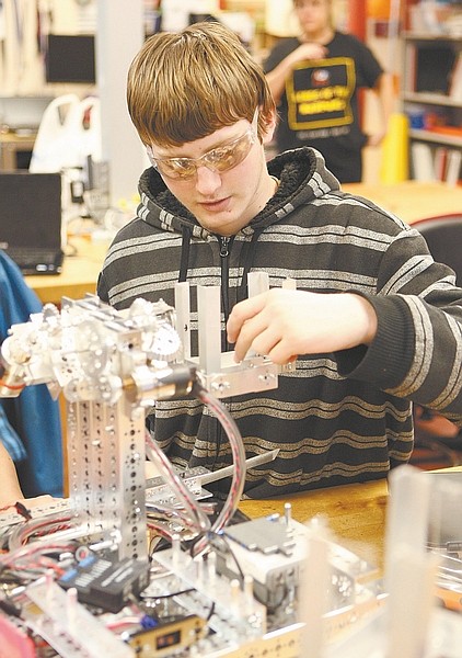 Photos by Shannon Litz/Nevada AppealLeft: Nate Shek, of the Silver State Charter High School team Robo Magic, works on the team&#038;#8217;s robot on Saturday.