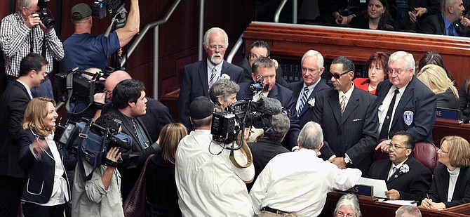 Jim Grant / Nevada Appeal Assemblyman Steven Brooks takes his seat in the Nevada Assembly surrounded by media on Monday.