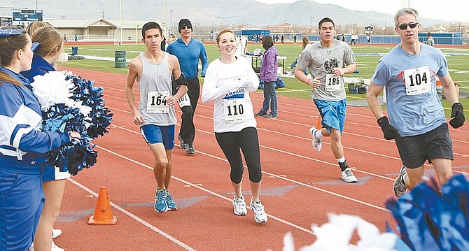 PHOTOS BY Shannon Litz/ Nevada AppealCarson High School cheerleaders line the route of the Safe Grad 5K at CHS-on Saturday.