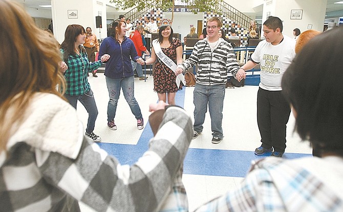Shannon Litz/Nevada Appeal Miss Washoe Olivia Rupert, 18, at Carson High School senior, leads a dance in Senator Square during lunch at the school on Wednesday.