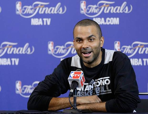 San Antonio Spurs point guard Tony Parker smiles as he speaks during a news conference after basketball practice, Friday, June 7, 2013, in Miami. The Miami Heat and the Spurs are scheduled to play Game 2 of the NBA Finals on Sunday. (AP Photo/Wilfredo Lee)