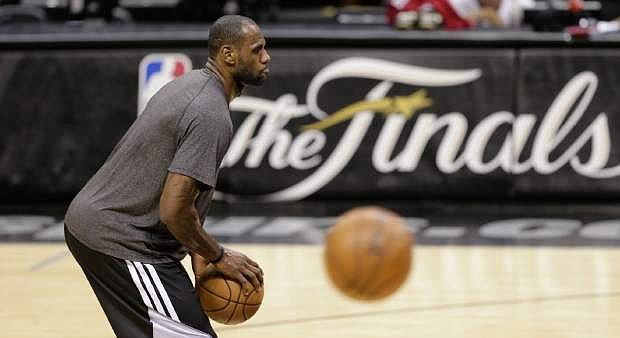 Miami Heat&#039;s LeBron James takes part in NBA basketball practice Wednesday, June 12, 2013, in San Antonio. The Heat trail the San Antonio Spurs 2-1 in the best-of-seven games series. Game 4 of the NBA finals series is scheduled for Thursday. (AP Photo/Eric Gay)