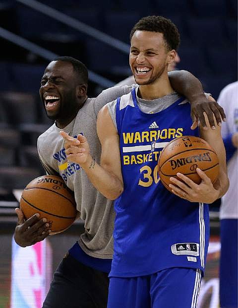 Golden State Warriors&#039; Draymond Green, left, and Stephen Curry laugh during an NBA basketball practice, Wednesday, June 3, 2015, in Oakland, Calif. The Warriors host the Cleveland Cavaliers in Game 1 of the NBA Finals on Thursday. (AP Photo/Ben Margot)