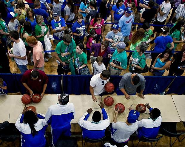 Fans wait in line to get autographs from the team during an NCAA college basketball pep rally for the Florida Gulf Coast men&#039;s team at Alico Arena on Monday, March 25, 2013, in Fort Myers, Fla.  FGCU is scheduled to play Florida on Friday in the South Regional semifinals game of the NCAA college basketball tournament. (AP Photo/Naples Daily News, William DeShazer)  FORT MYERS OUT