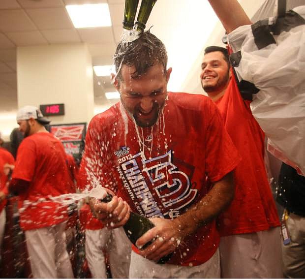 St. Louis Cardinals starting pitcher Michael Wacha is doused by teammate Joe Kelly as they celebrate in the locker room after Game 6 of the National League Championship Series between the St. Louis Cardinals and the Los Angeles Dodgers on Friday, Oct. 18, 2013, at Busch Stadium in St. Louis. (AP Photo/St. Louis Post-Dispatch, Chris Lee)
