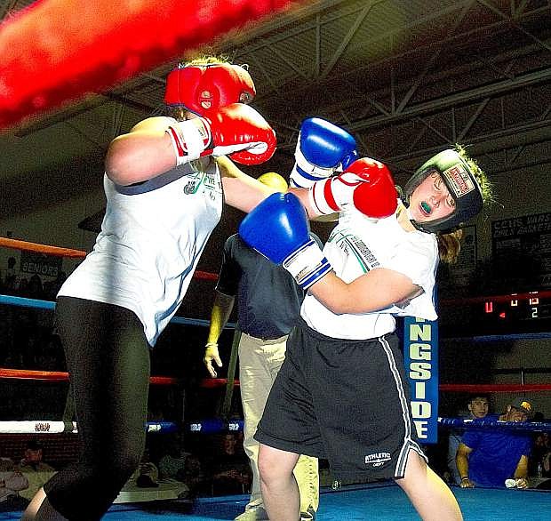 Emily Coleman, left, lands a blow during her bout with Katelynn White during Friday&#039;s Night of Boxing.