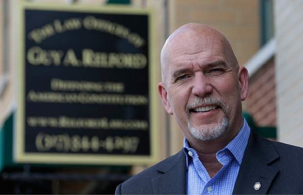 In this photo taken on Friday, April 18, 2014, Guy Relford, an attorney specializing in gun rights, poses outside his law office in Carmel, Ind. Redford is also the owner and instructor at Tactical Firearms Training teaching firearm safety as well as a comprehensive Indiana gun law course.   (AP Photo/Michael Conroy)