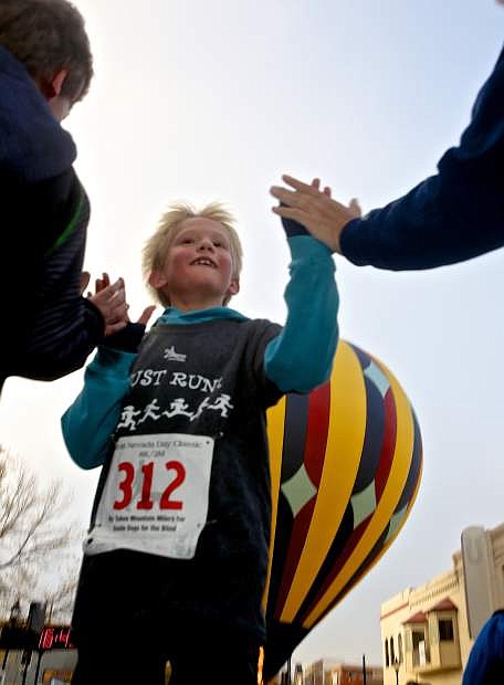 8-year-old Henry Cartier is the first finisher in the kid&#039;s 2-mile run Saturday.