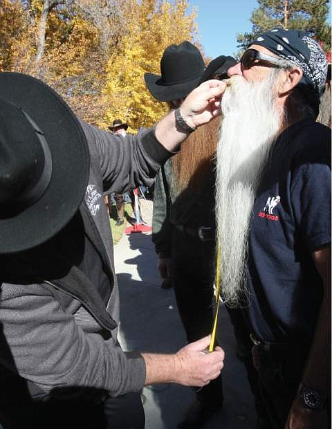 Carson City resident Michael Scott Cain has his beard measured at the Nevada Day Beard Contest on Saturday.