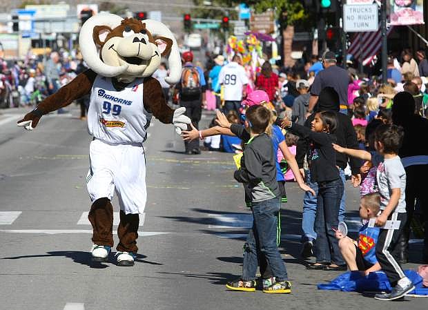 The Reno Bighorns mascot high-5&#039;s children during the parade.
