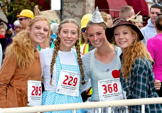 Wizard of Oz characters Mallory Otto, Sophia Ruedy, Alana Burson and Molly Otto await the start of the 2 mile run Saturday.