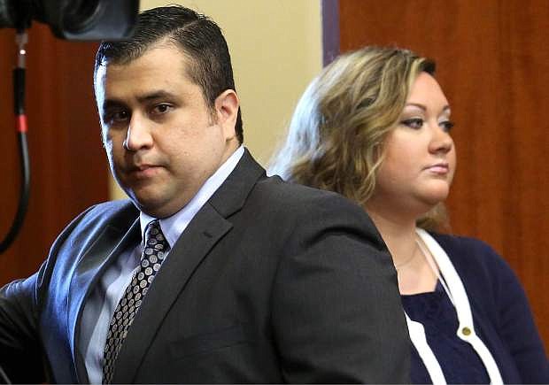 In this June 24, 2013 file photo, George Zimmerman, left, arrives in Seminole circuit court, with his wife Shellie, in Sanford, Fla. Shellie Zimmerman called police on Monday, Sept. 9, 2013, saying her husband threatened her and her dad with a gun. Zimmerman was acquitted in the 2012 shooting death of Trayvon Martin. (AP Photo/Orlando Sentinel, Joe Burbank, Pool, File)
