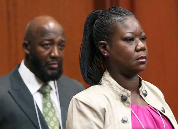 Trayvon Martin&#039;s parents, Tracy Martin, left, and Sybrina Fulton, enter the courtroom during George Zimmerman&#039;s trial in Seminole County circuit court in Sanford, Fla. Tuesday, June 25, 2013. Zimmerman has been charged with second-degree murder for the 2012 shooting death of Trayvon Martin. (AP Photo/Orlando Sentinel, Gary W. Green, Pool)