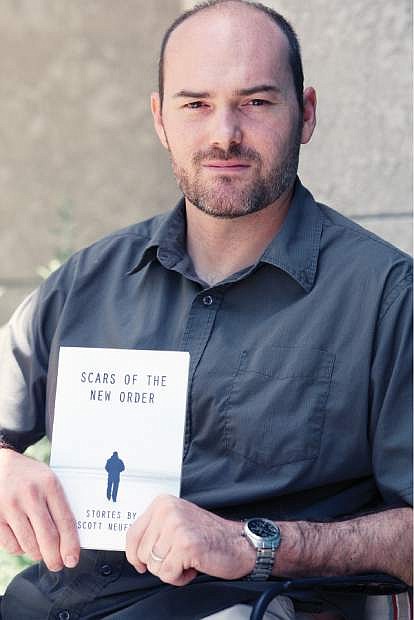 Scott Neuffer poses with his new book on Friday.