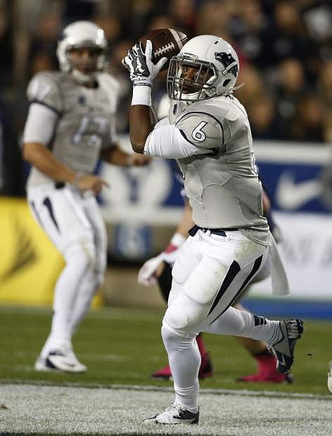 Nevada running back Don Jackson, right, catches a pass against BYU during the first half of an NCAA college football game in Provo, Utah, Saturday, Oct. 18, 2014. Nevada beat BYU 42-35. (AP Photo/George Frey)