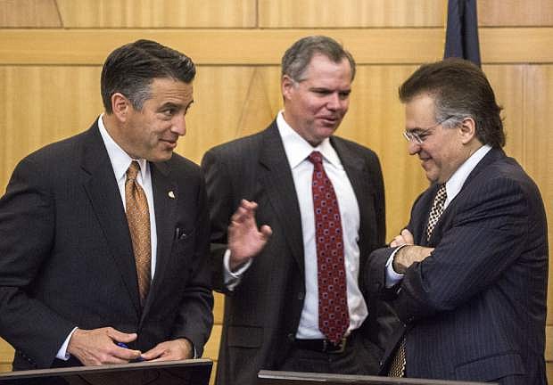 Nevada Gov. Brian Sandoval, from left, Bill Murren, CEO of MGM Resorts International, and Tony Alamo, chairman of Nevada Gaming Commission, talk during the Gaming Policy Committee meeting to discuss &quot;esports&quot; in Las Vegas on Friday, May 13, 2016. (Jeff Scheid/Las Vegas Review-Journal via AP) MANDATORY CREDIT
