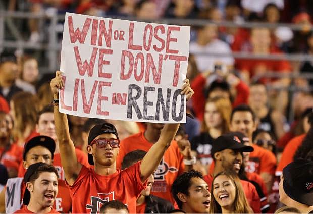 A San Diego State student holds a sign during an NCAA college football game against Nevada, Friday, Oct. 4, 2013, in San Diego. (AP Photo/Lenny Ignelzi)