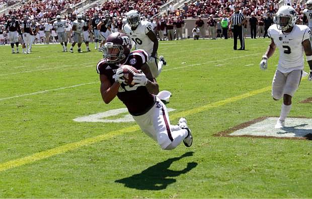 Texas A&amp;M wide receiver Jeremy Tabuyo (19) catches a touchdown pass against Nevada during the second half of an NCAA college football game Saturday, Sept. 19, 2015, in College Station, Texas. Texas A&amp;M won 44-27. (AP Photo/David J. Phillip)