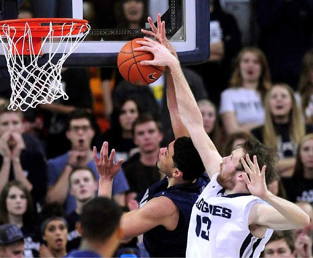 Utah State&#039;s David Collette blocks a shot by Nevada&#039;s AJ West during an NCAA college basketball game, Tuesday, Feb. 10, 2015, in Logan, Utah. (AP Photo/Herald Journal, John Zsiray)