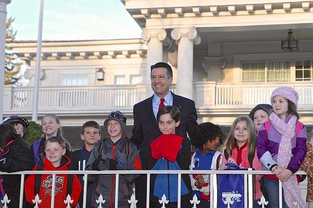 Nevada Governor Brian Sandoval poses with schoolchildren in front of the Governor&#039;s Mansion Wednesday morning prior to walking to school with them for Nevada Moves.