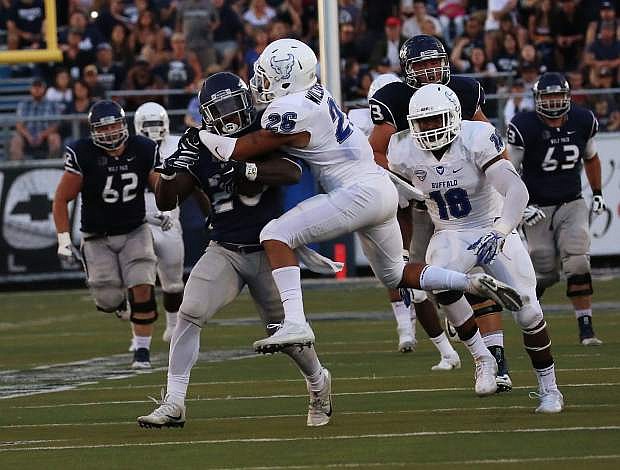 James Butler carries Ryan Wiliamson on a long game for Nevada Saturday.