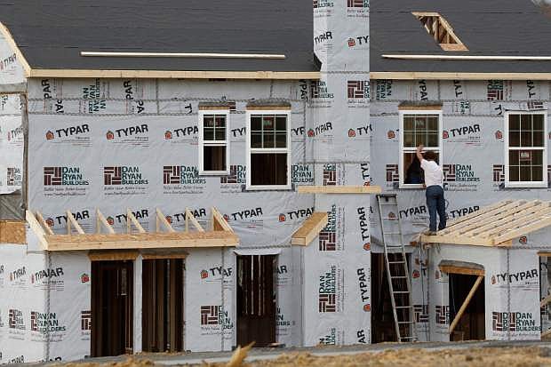 In this photo made on Friday, March 28, 2014, construction continues on a housing plan in Zelienople, Pa. The Commerce Department releases new home sales for March on Wednesday, April 23, 2014. (AP Photo/Keith Srakocic)